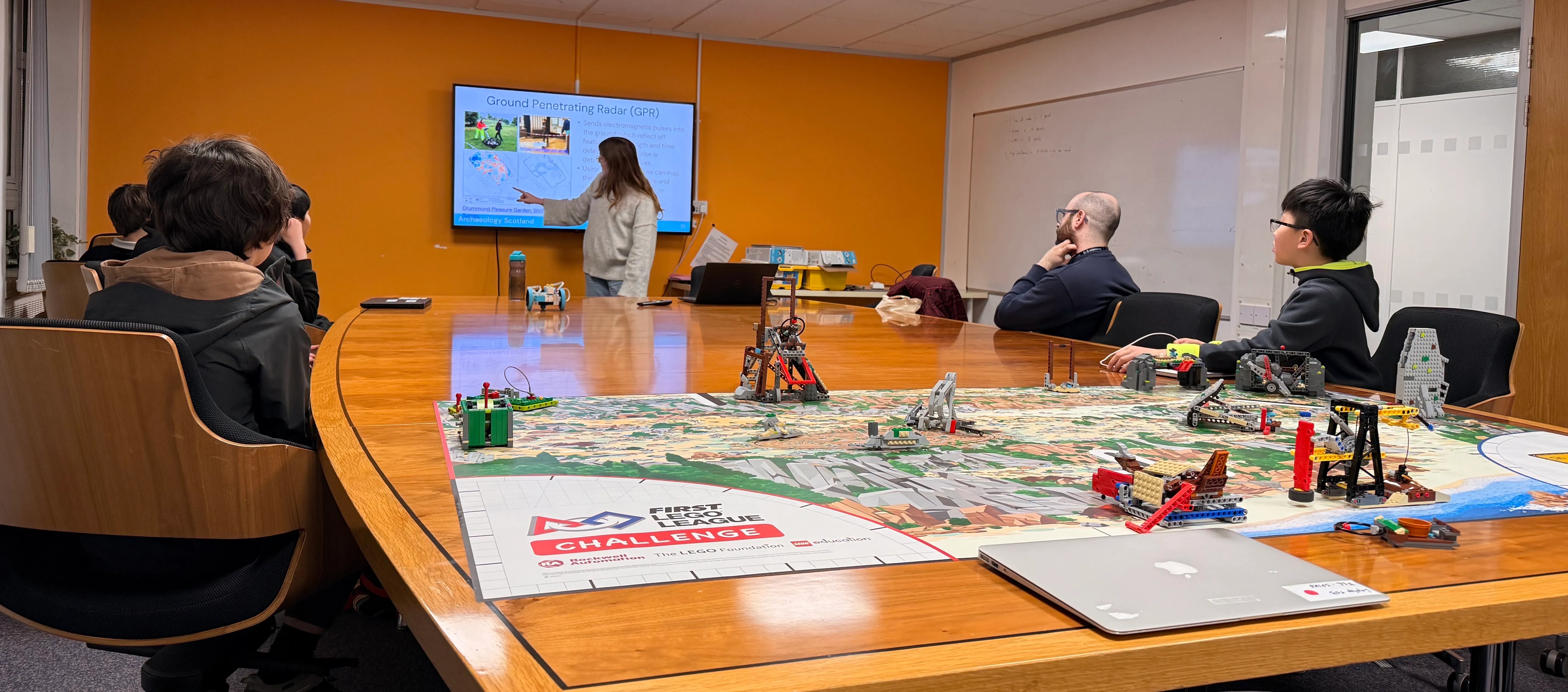 Archaeologist Calypso Finch presenting about her work to our teams.