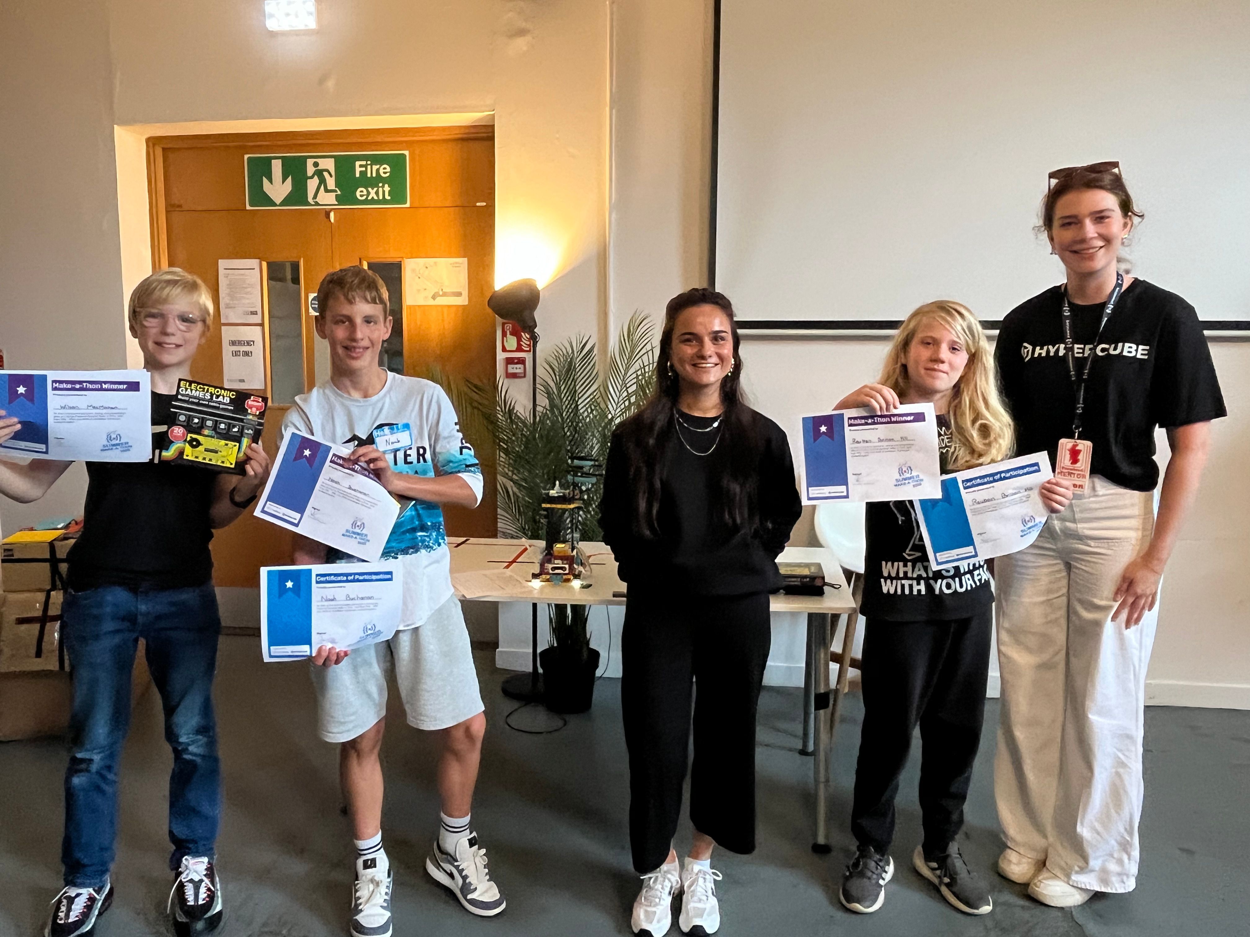 The three winners of the Make-a-Thon presenting their awards and prizes together with a Prewired mentor and competition judge