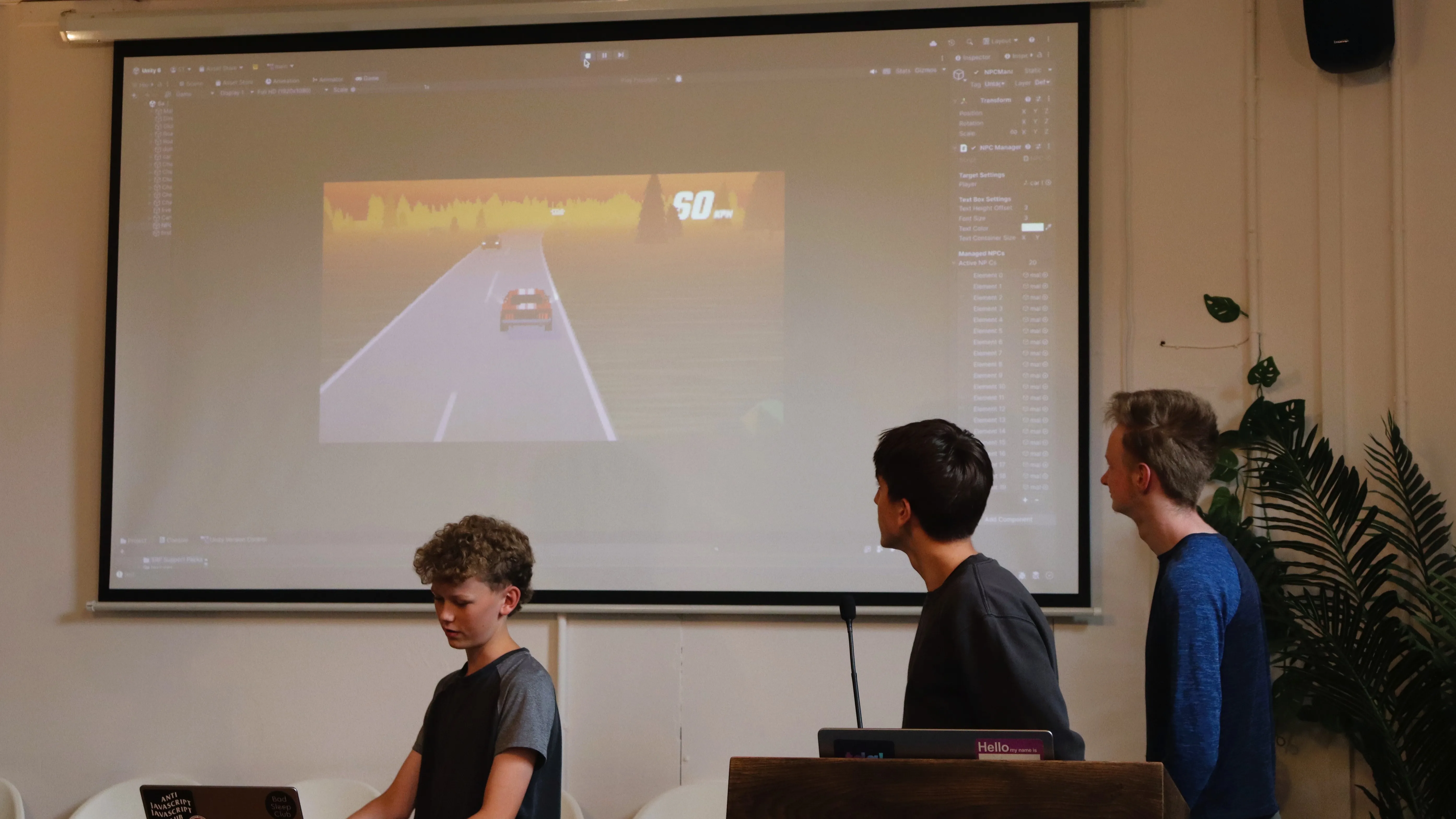 Dovish Developers showing off their game on a projector screen