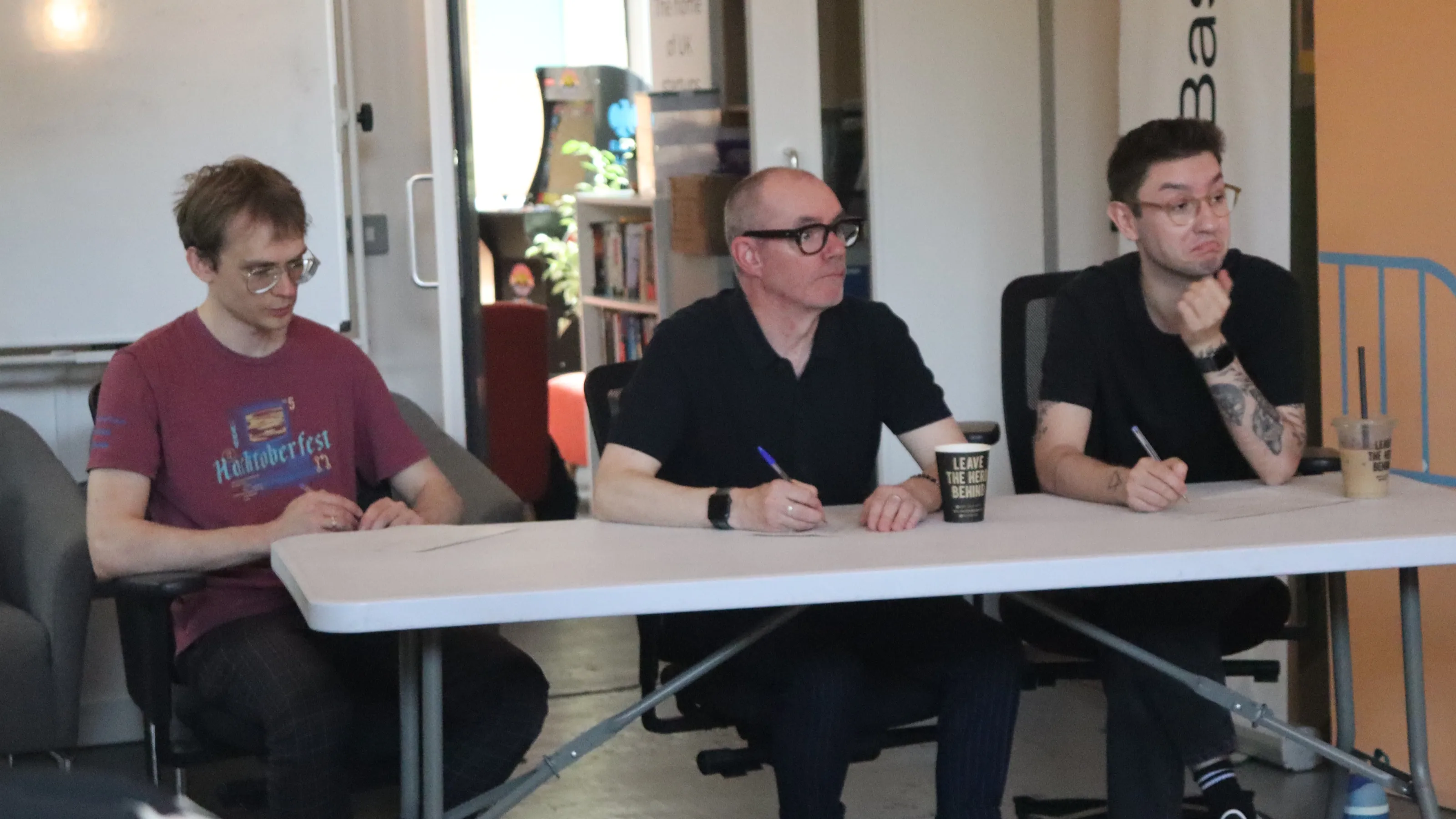 The three judges, listening to a presentation